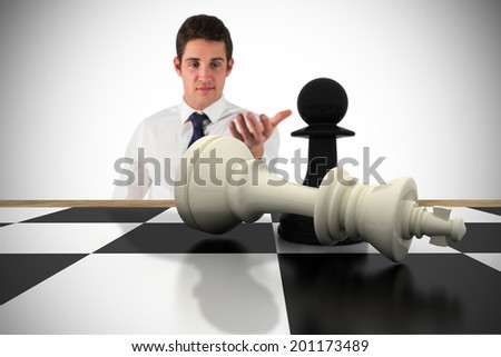 Businessman standing with hand out with chessboard against white background with vignette