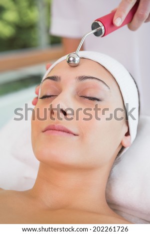 Peaceful brunette getting micro dermabrasion in the health spa
