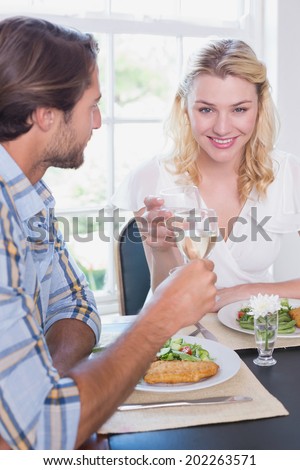 Happy couple enjoying a meal together at home in the dining room