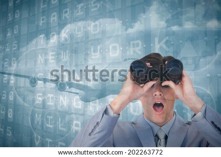 Suprised businessman looking through binoculars against departures board for major cities