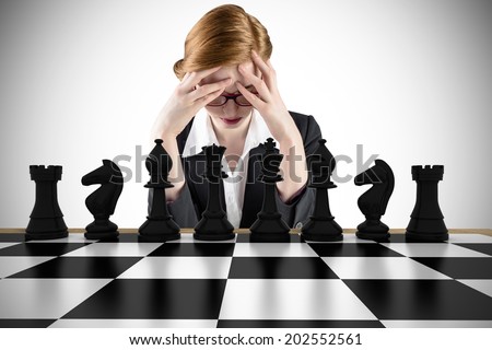 Composite image of redhead businesswoman with head in hands with chessboard