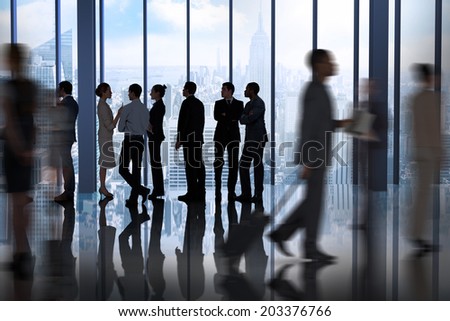Composite image of business colleagues talking against room with large window looking on city