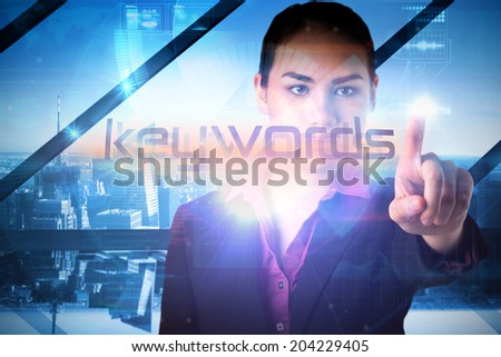 Businesswoman presenting the word keywords against room with large window looking on city