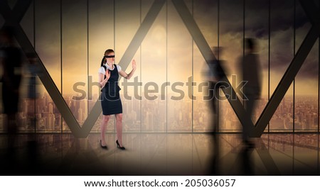 Redhead businesswoman in a blindfold against room with large window looking on city