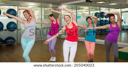Class dancing in studio at the gym