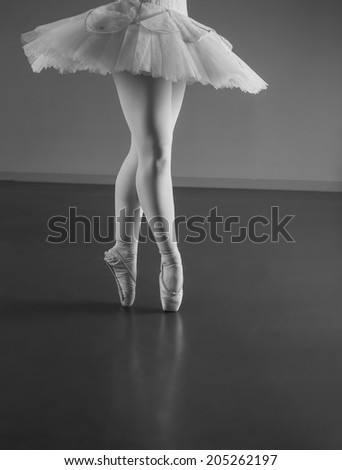 Graceful ballerina standing en pointe in the ballet studio