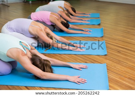 Yoga class in childs pose in fitness studio at the leisure center