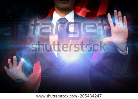 Businessman presenting the word target against shiny red arrows on black background
