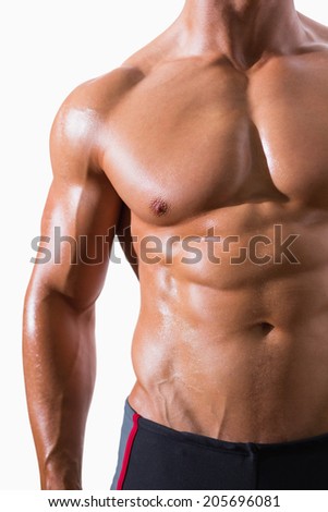 Mid section of shirtless muscular man standing over white background