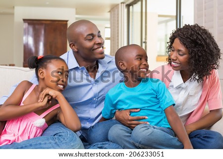 Happy family relaxing on the couch at home in the living room