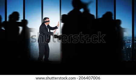 Silhouette of business people walking against room with large window looking on city