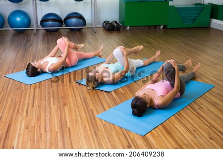 Yoga class stretching in fitness studio at the leisure center
