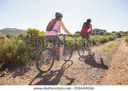 Active couple on a bike ride in the countryside on a sunny day