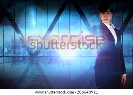 Businesswoman presenting the word exercise against room with large window looking on city