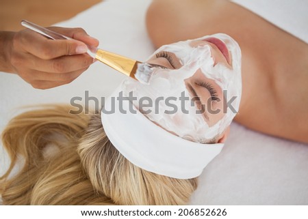 Beautiful blonde getting a facial treatment at the health spa