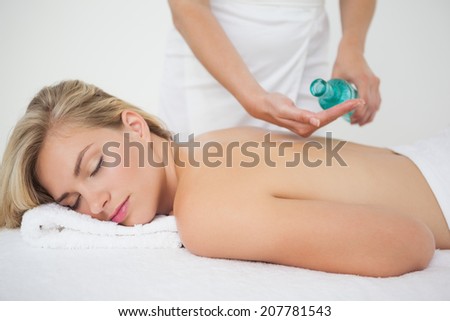 Beautiful blonde enjoying a back massage at the health spa