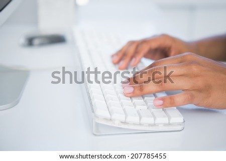 Businesswoman typing on a keyboard in her office