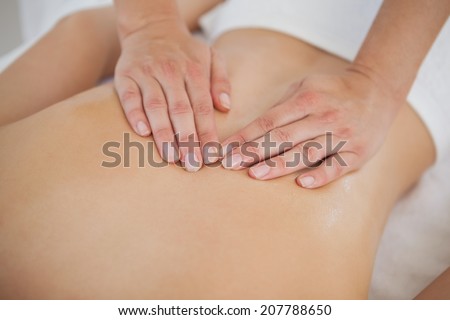 Woman enjoying a back massage at the health spa