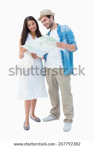 Happy hipster couple looking at map on white background