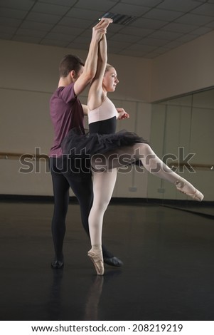 Ballet partners dancing gracefully together in the ballet studio