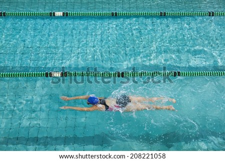 Female swimmer training by herself in swimming pool at the leisure centre