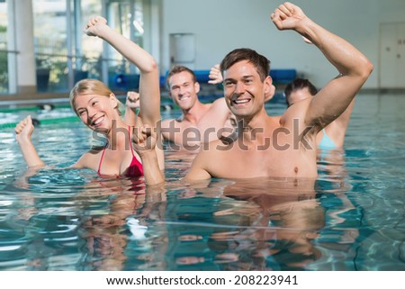 Fitness class doing aqua aerobics in swimming pool at the leisure centre