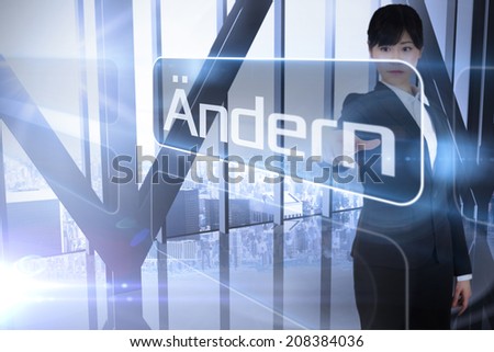 Businessman pointing to the word change in german against room with large window looking on city