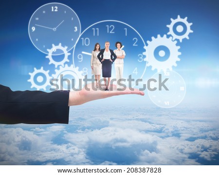 Team of businesswomen looking at camera against blue sky over clouds at high altitude