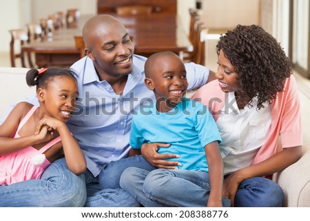 Family relaxing together on the sofa at home in the living room