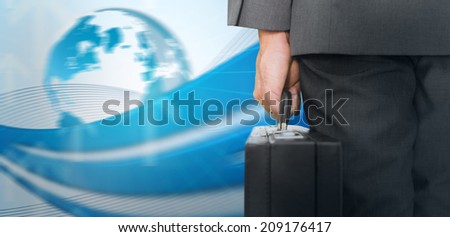 Businessman holding briefcase against global business graphic in blue