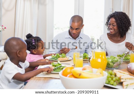 Happy family enjoying a healthy meal together at home in the kitchen