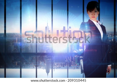 Businesswoman presenting the word solution against room with large window looking on city