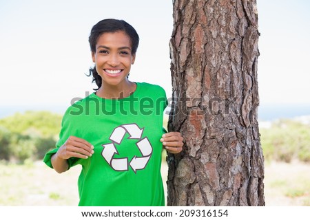 Pretty environmental activist showing her t-shirt on a sunny day in the countryside