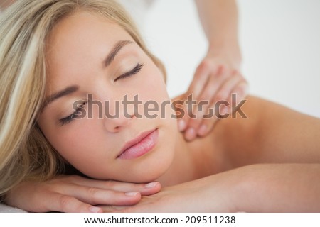 Pretty blonde enjoying a massage at the health spa