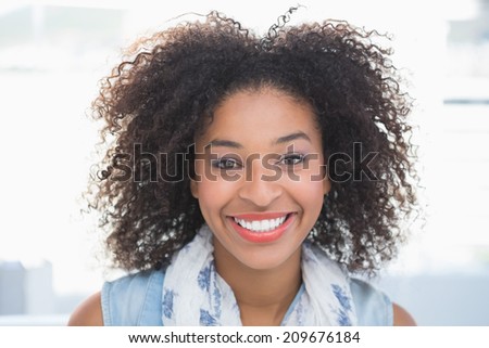 Pretty designer smiling at camera in her office