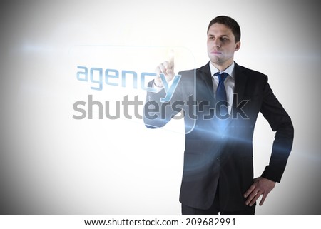 Businessman pointing to word agency against white background with vignette