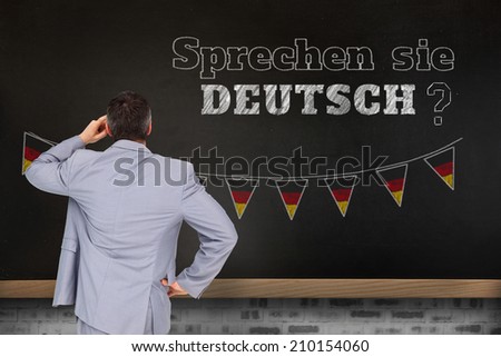 Thinking businessman against blackboard on wall, Do you speak German?