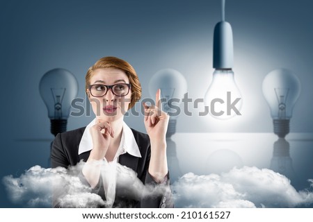 Thinking redhead businesswoman against five light bulbs in a row with one lit up