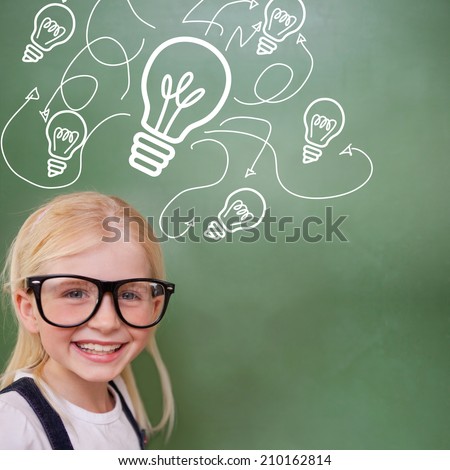 Cute pupil smiling against idea and innovation graphic