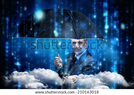 Mature businessman holding an umbrella against lines of blue blurred letters falling