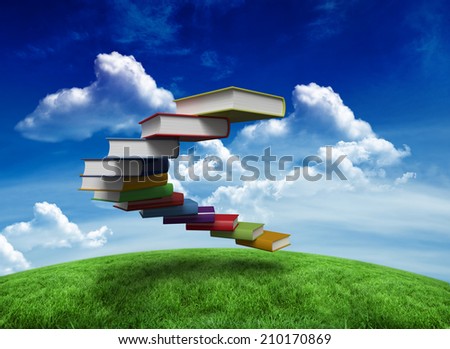 Steps made of books against green field under blue sky