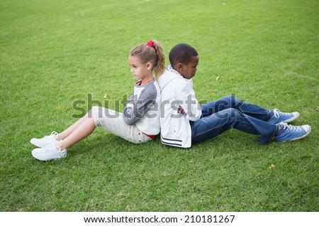 Young friends not talking to each other after fight in the park