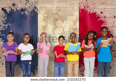 Elementary pupils reading books against france flag in grunge effect