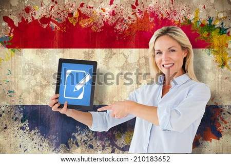 Mature student pointing to tablet against grunge dutch flag