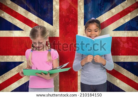 Elementary pupils reading against union jack flag in grunge effect