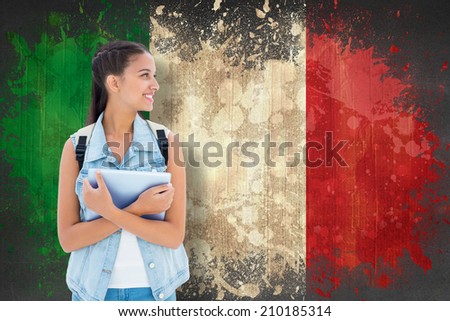 Student holding tablet pc against italy flag in grunge effect