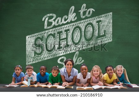 Cute pupils smiling at camera with teacher against green chalkboard with back to school message