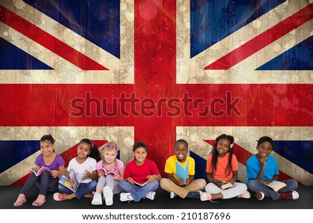 Cute pupils smiling at camera with books against union jack flag in grunge effect
