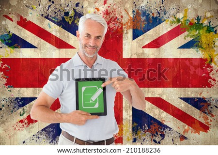 Mature student showing tablet pc against grunge union jack flag