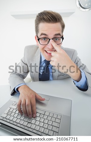Excited businessman working on laptop in his office